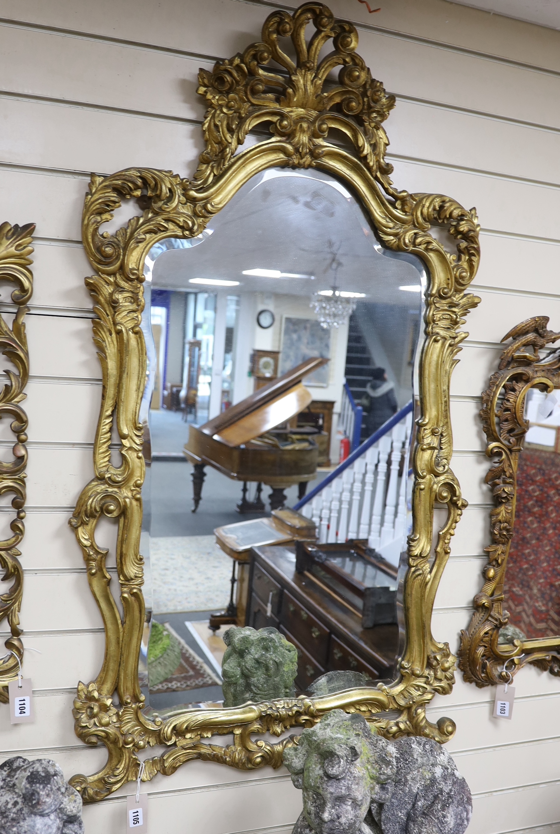 An 18th century style carved giltwood and composition wall mirror, width 72cm, height 124cm